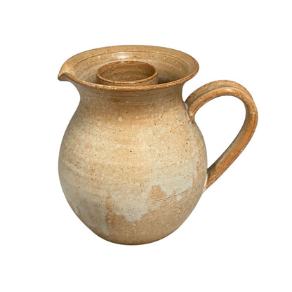 Brown ceramic pitcher on a white background
