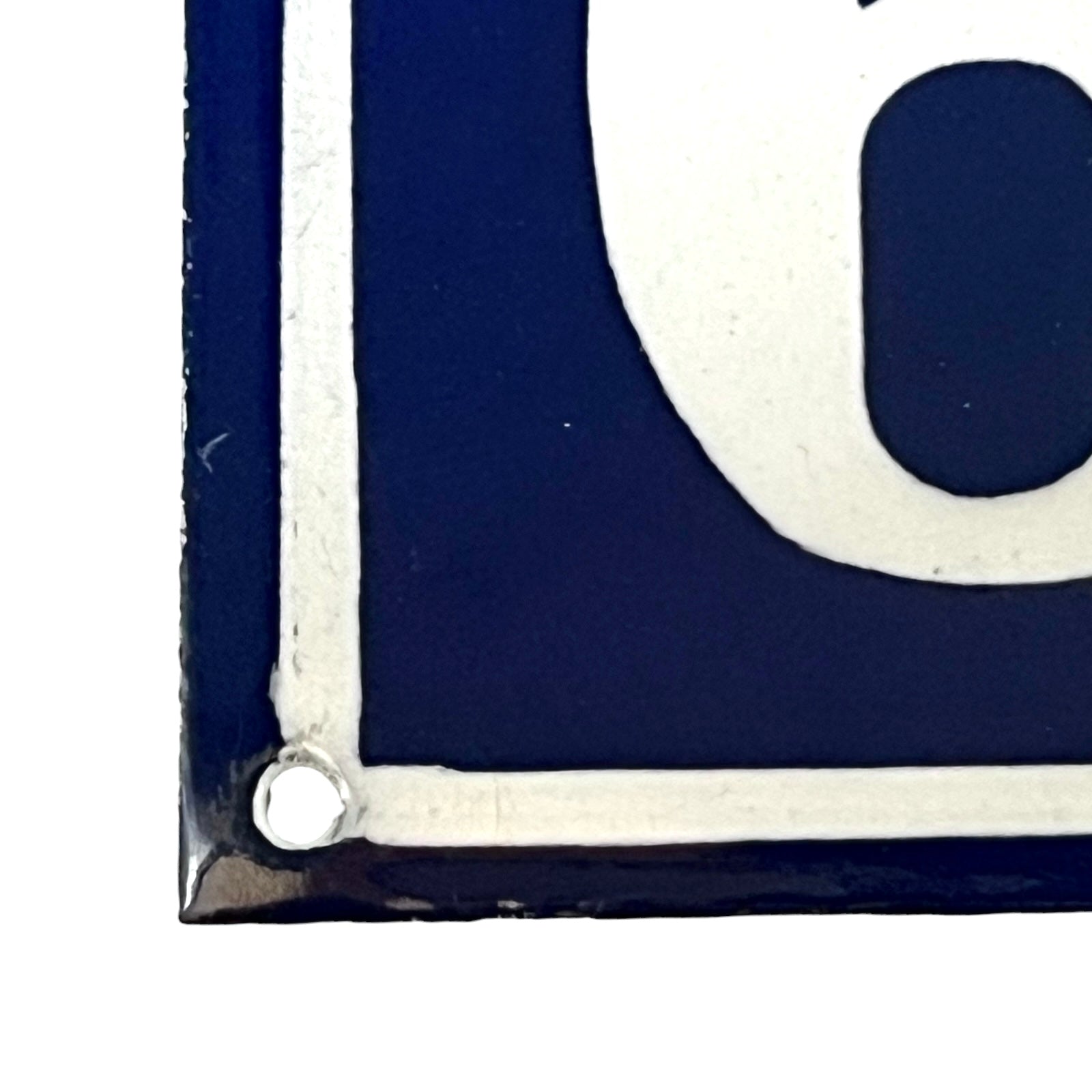 Close-up of a blue and white letter 'C' on a white background
