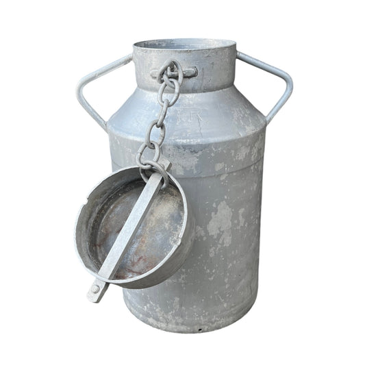Galvanized metal milk can with side handles, a chain, and a small attached metal scoop or ladle, shown on a plain white background.