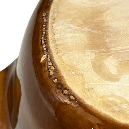 Close up of a rabbit shaped casserole dish on a white background