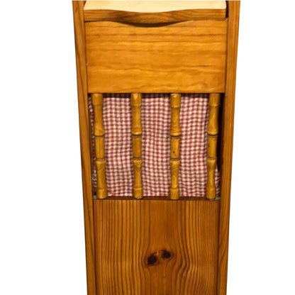 A close-up of a wooden French baguette box with a red and white gingham checkered fabric insert between the vertical slats, shown against a plain white background.