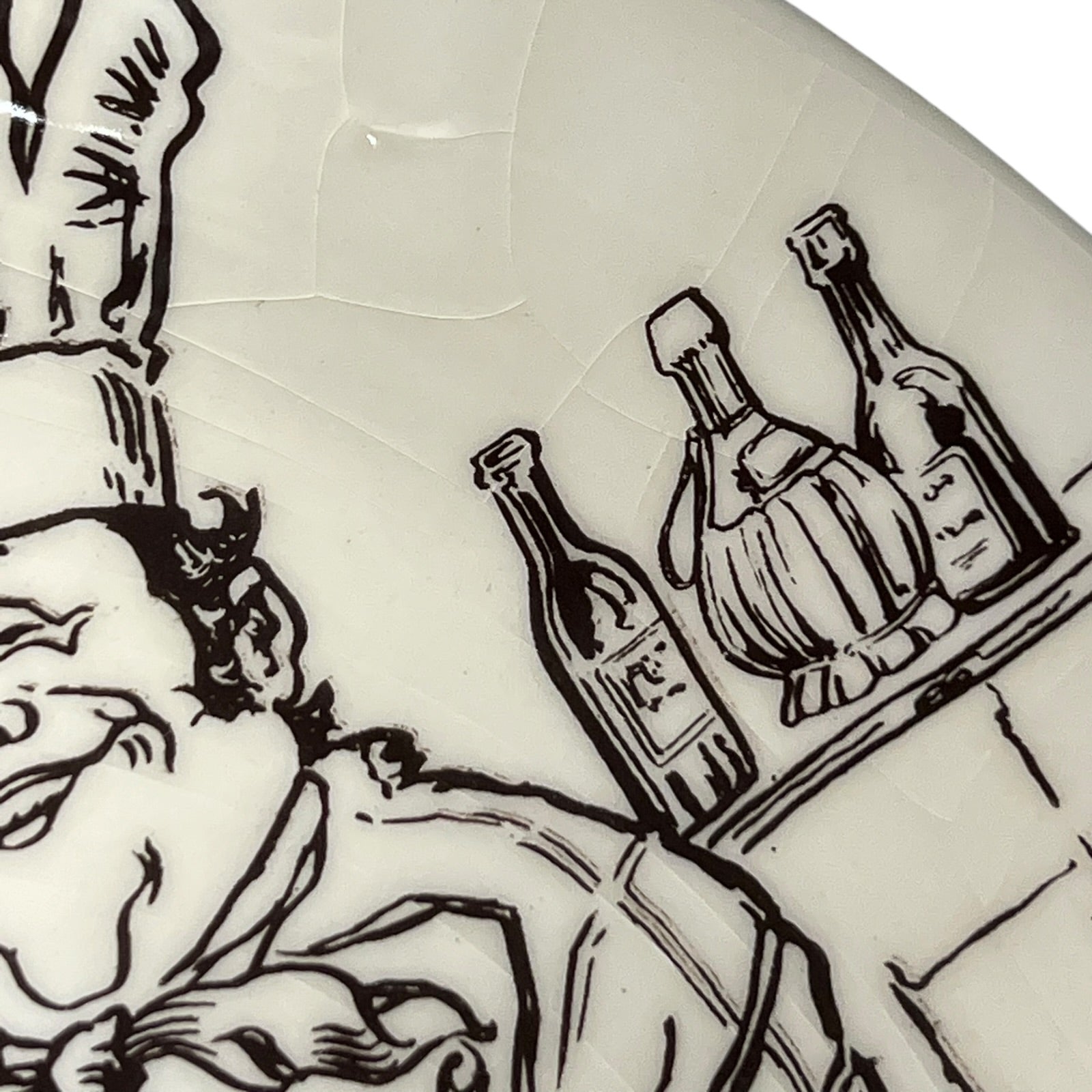 Decorative plate with black line art of a person holding bottles on a white background