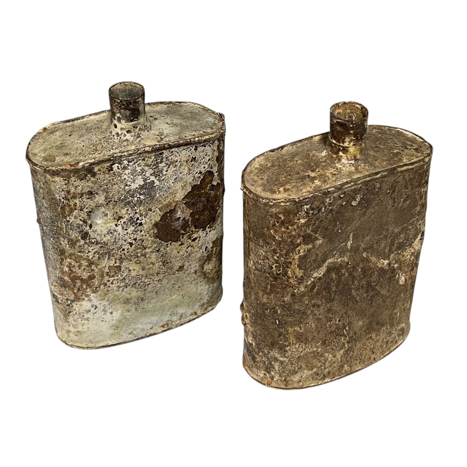 Pair of relic British WW1 metal water bottles in a rusty and flaky condition on a white background