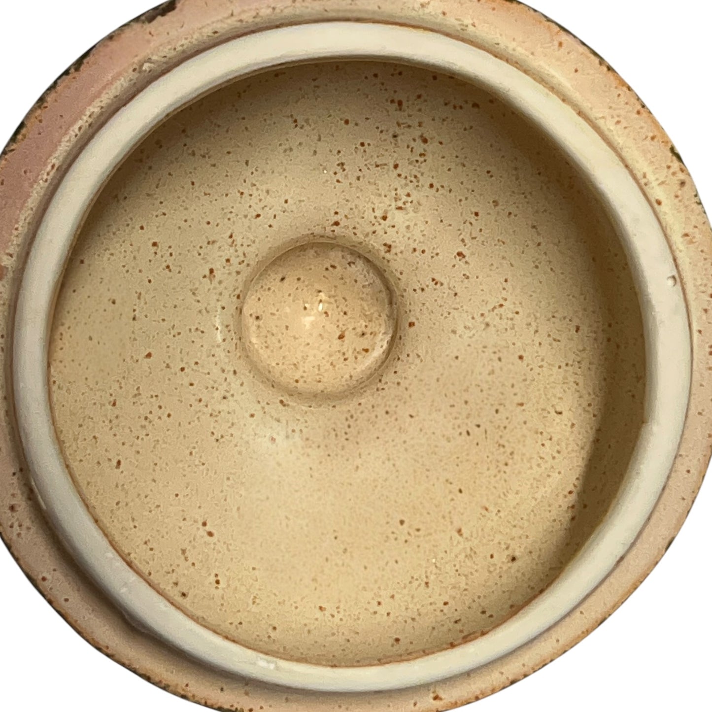 Close-up of a ceramic jar with embossed design on a white background