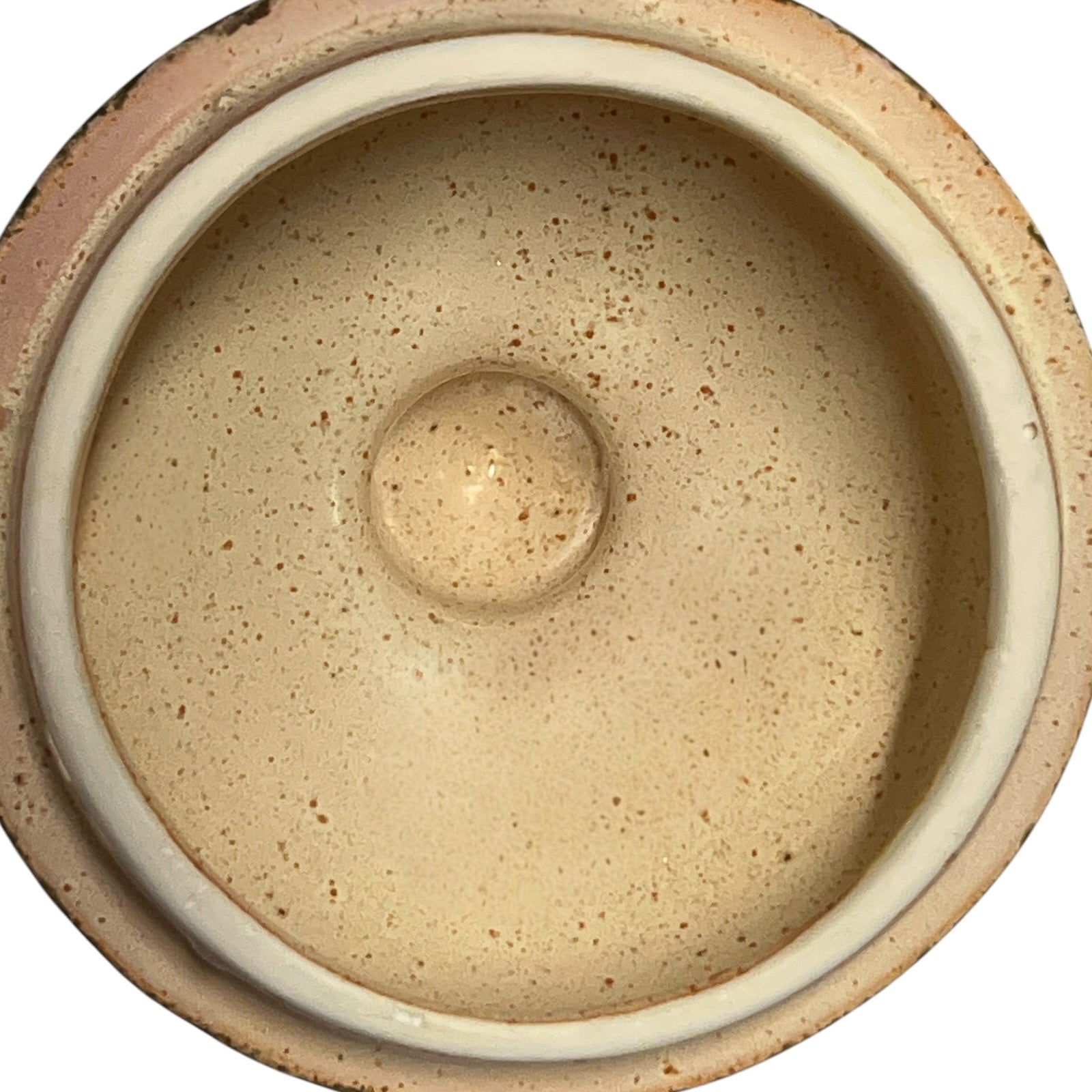 Close-up of a ceramic jar with embossed design on a white background