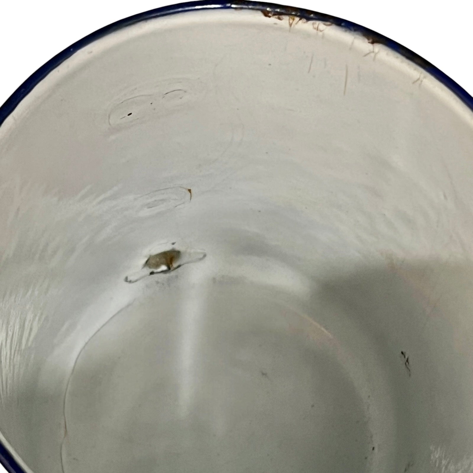 Close up of a French enamel vintage garden wall mounted planter or kitchen bathroom storage pot, on a white background 
