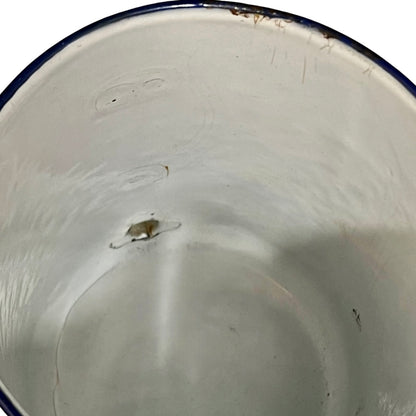Close up of a French enamel vintage garden wall mounted planter or kitchen bathroom storage pot, on a white background 