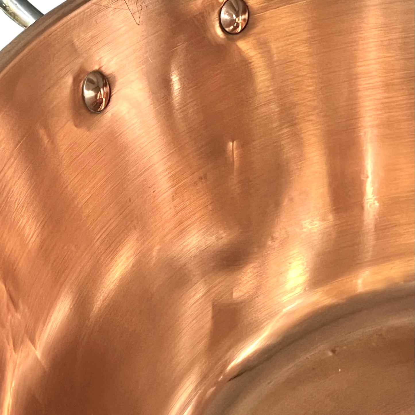 Close-up of a copper sink on a white background