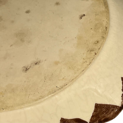Reverse of a French dinner plate on a white background
