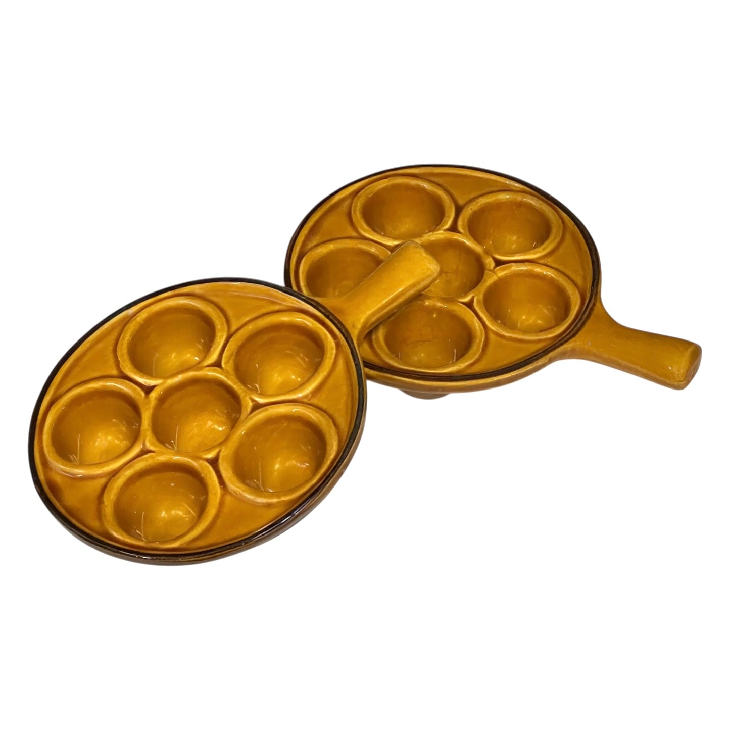 pair of amber-coloured French ceramic escargots plates with handles on a white background