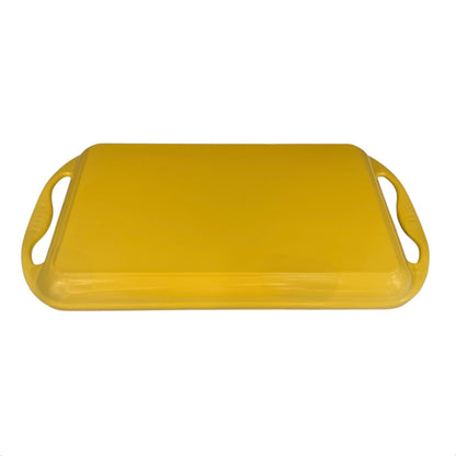Yellow Le Creuset griddle pan with handles on a white background