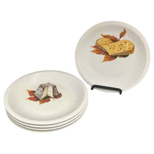 Set of porcelain plates with cheese-themed designs on a white background