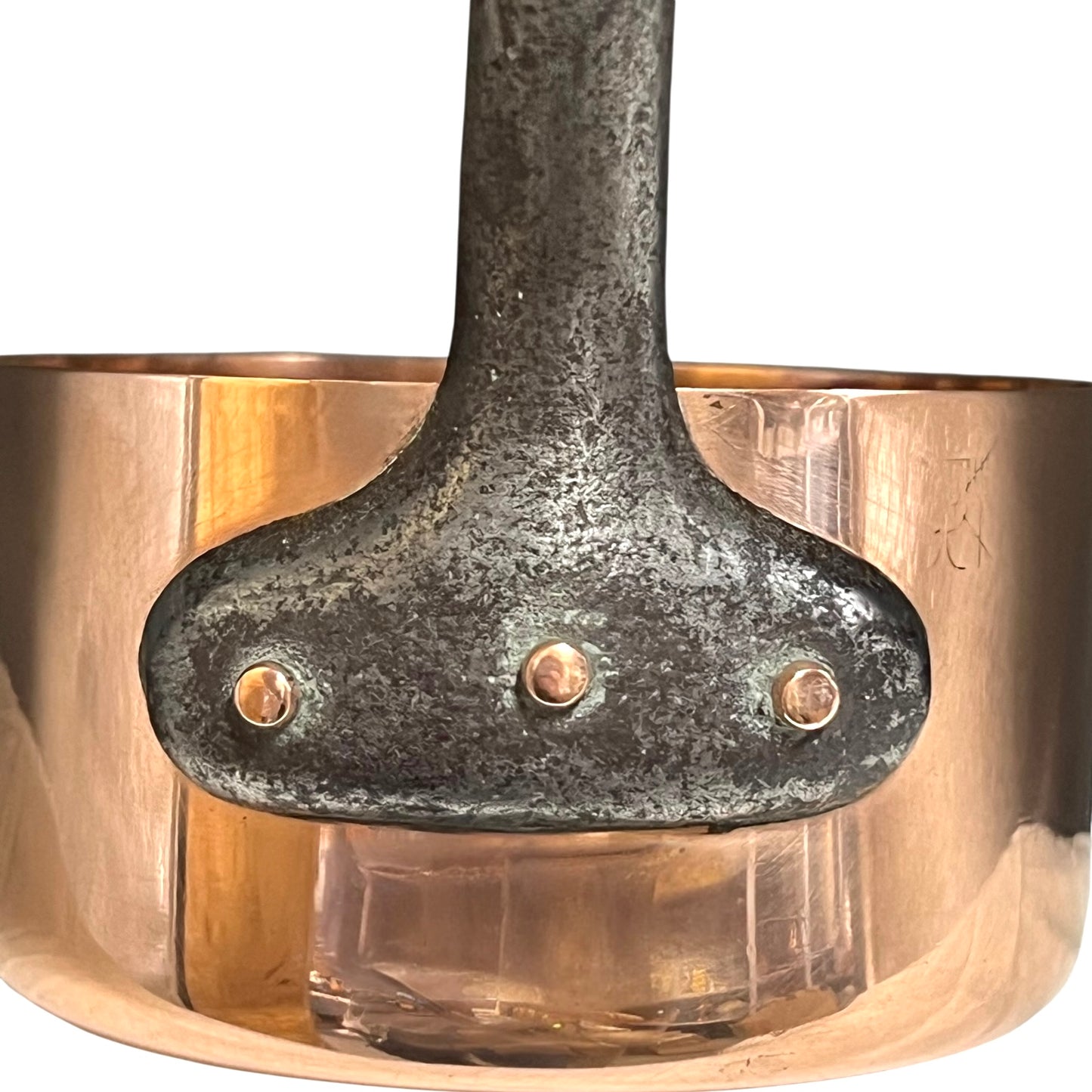 Close-up of a copper pot with a metal handle on a white background
