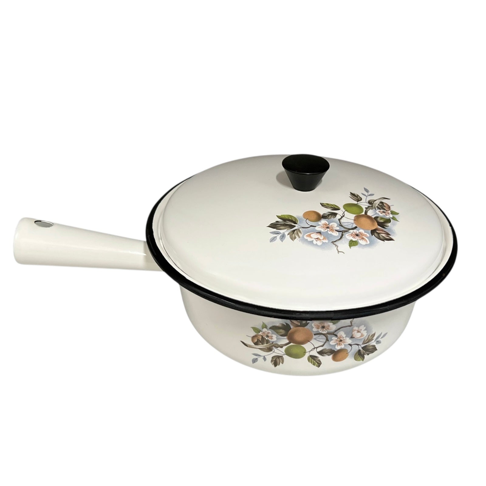 White enamel saucepan and lid with floral design on a white background