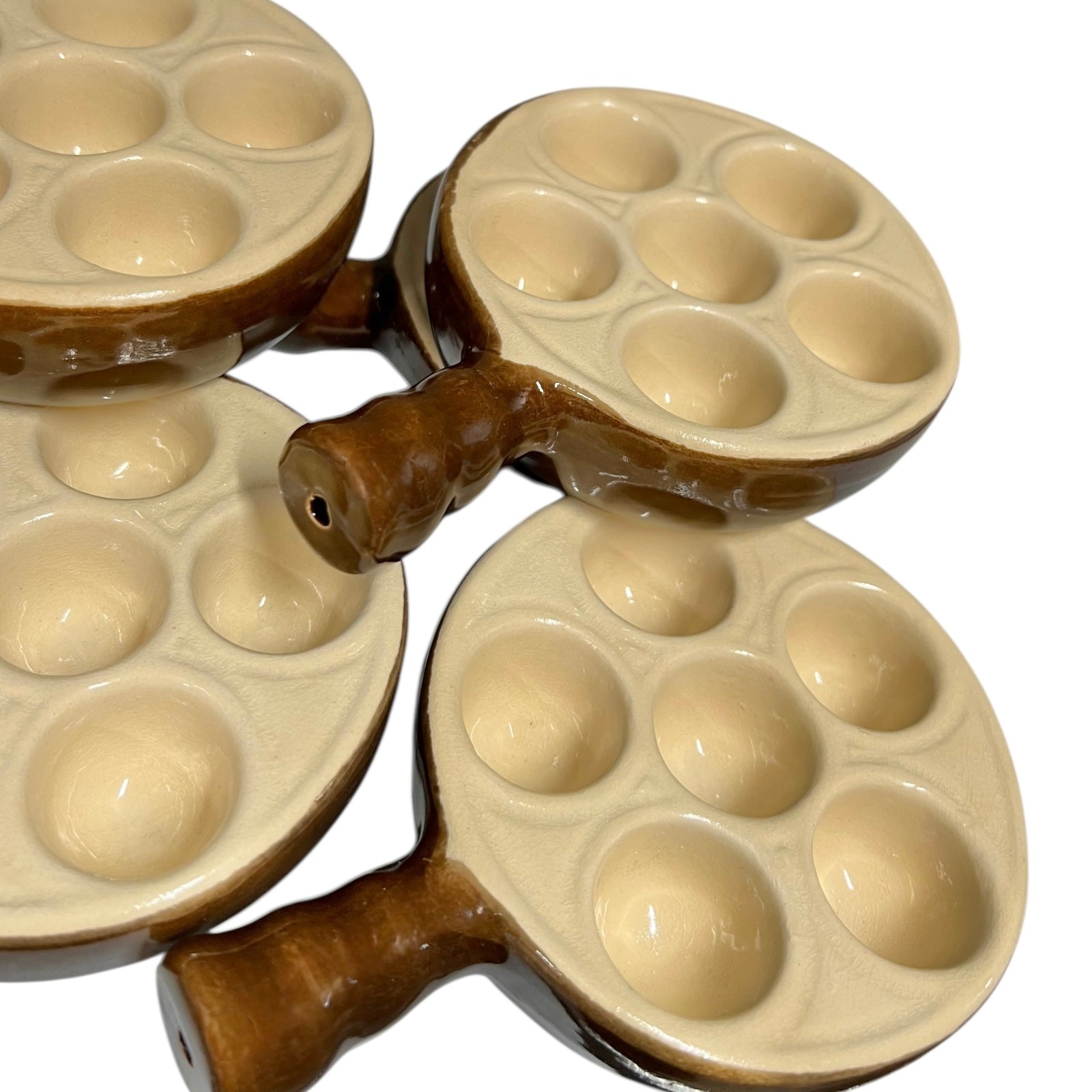 Close up of snail plates with handles on a white background