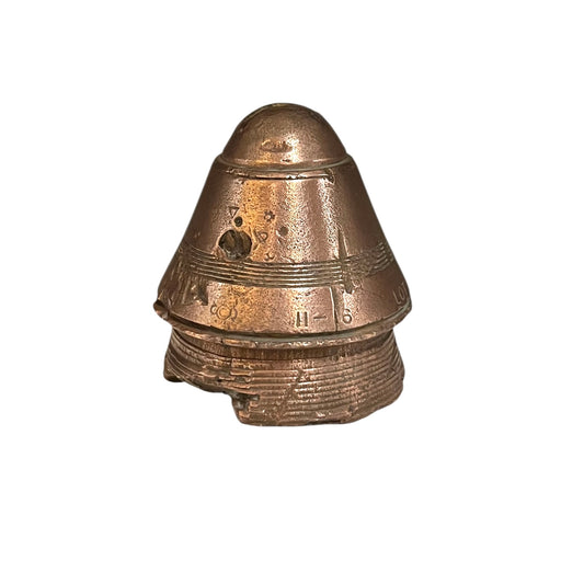 WW1 brass fuse paperweight on a white background 