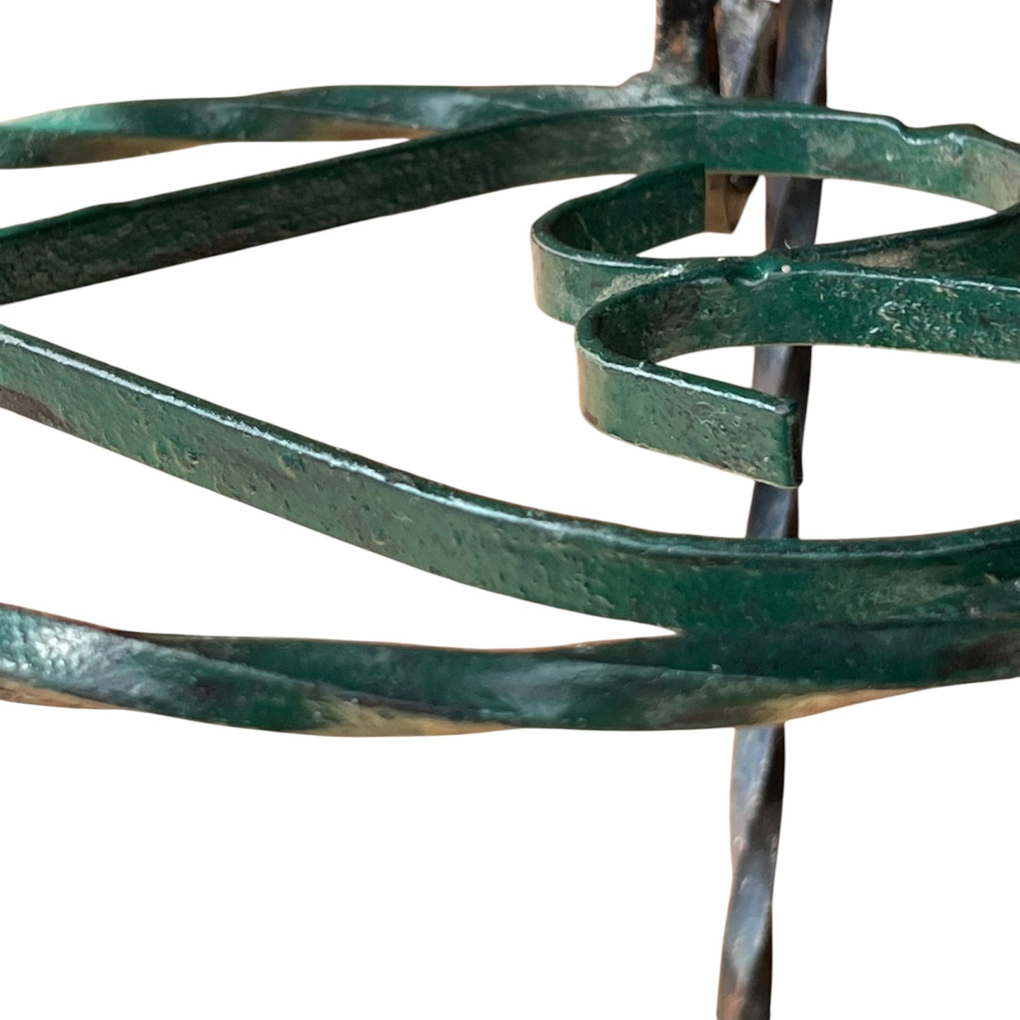 Close up of a wrought iron vintage plant stand on a white background 