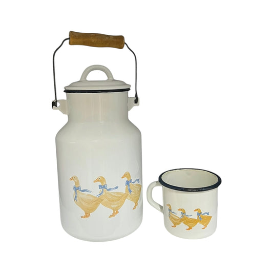 White enamel milk churn and mug with duck design on a white background
