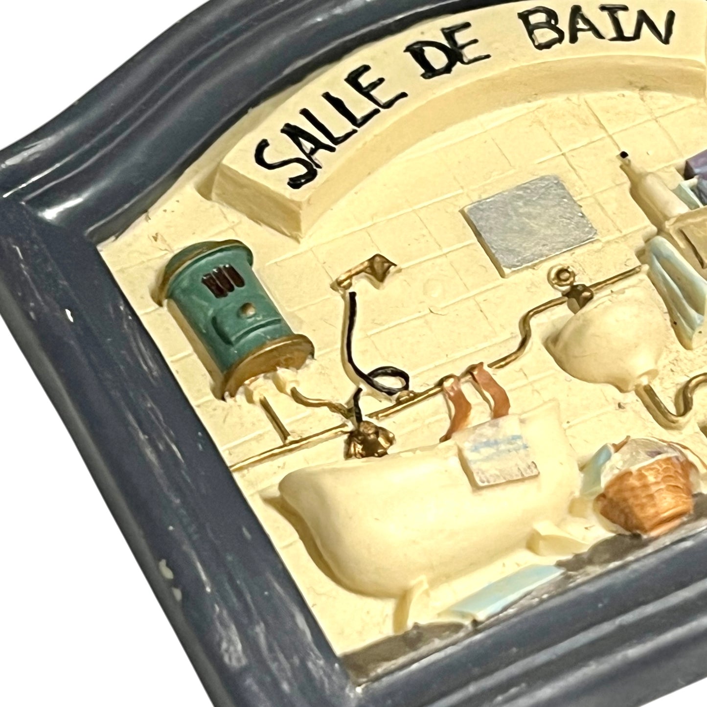 Close-up of a vintage bathroom door sign on a white background