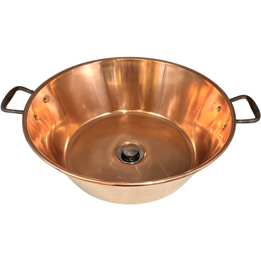 French copper bowl upcycled into a copper sink with iron handles and a chrome pop up waste on a white background