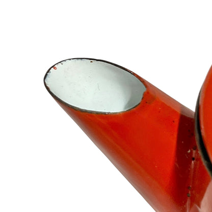 Close up of a red vintage French enamelled coffee pot on a white background