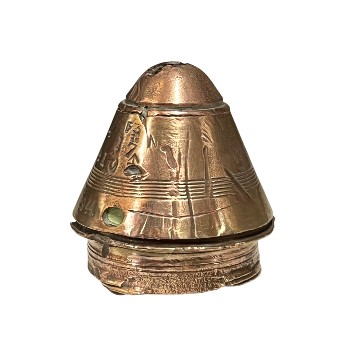 WW1 brass fuse paperweight with markings from use on a white background