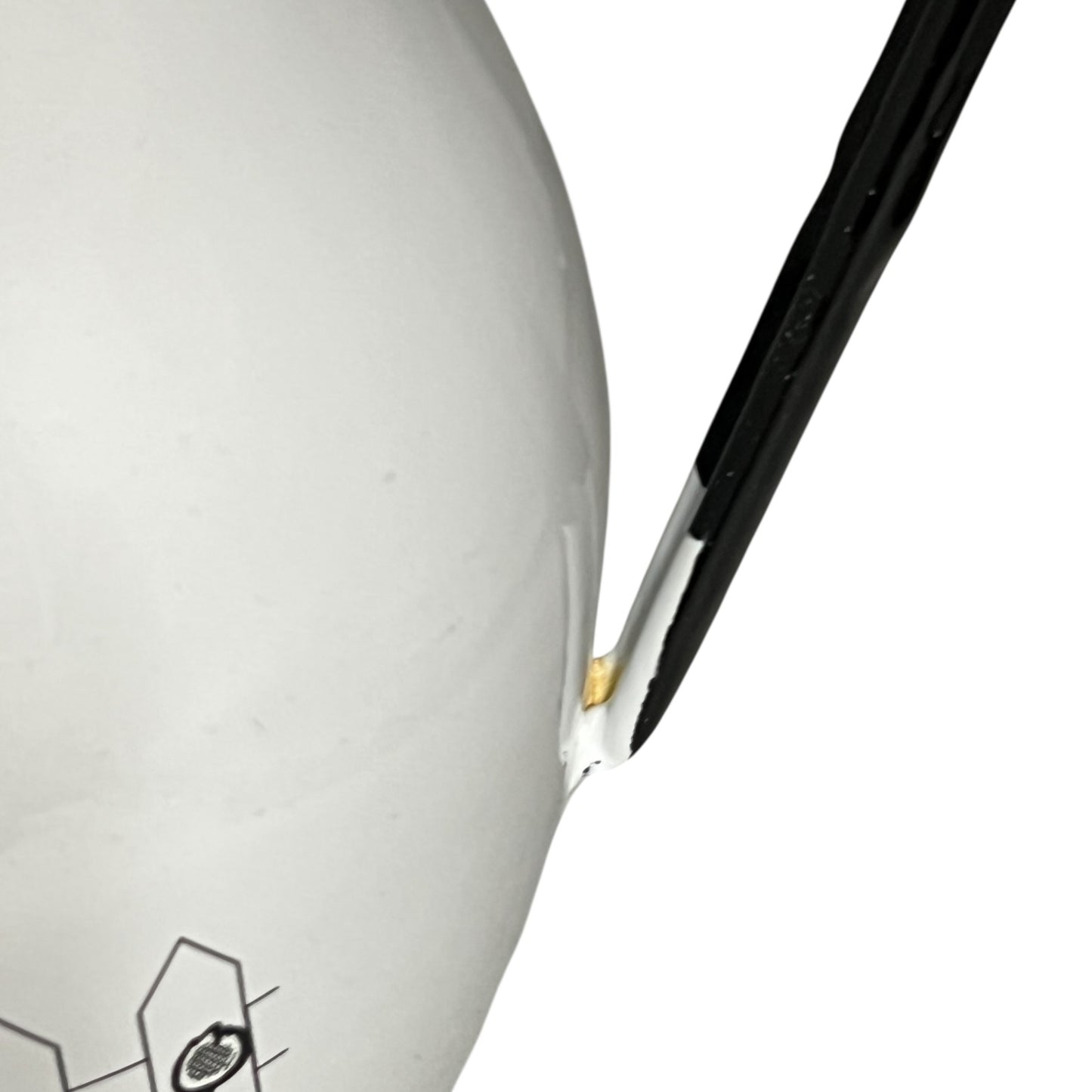 Close-up of a white jug with a black handle on a white background