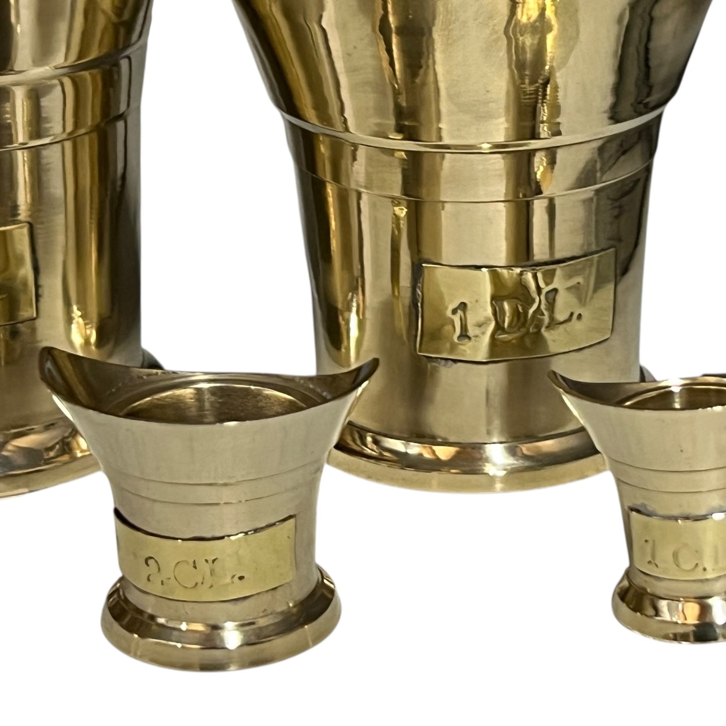 Set of gold metal cups on a white background