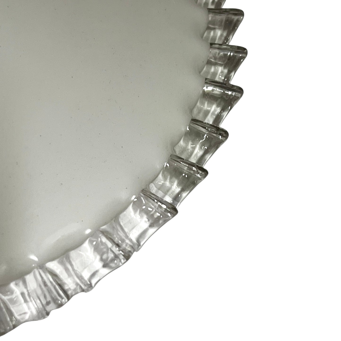 Close-up of a pendant light with white glass shade and brass fitting on a white background