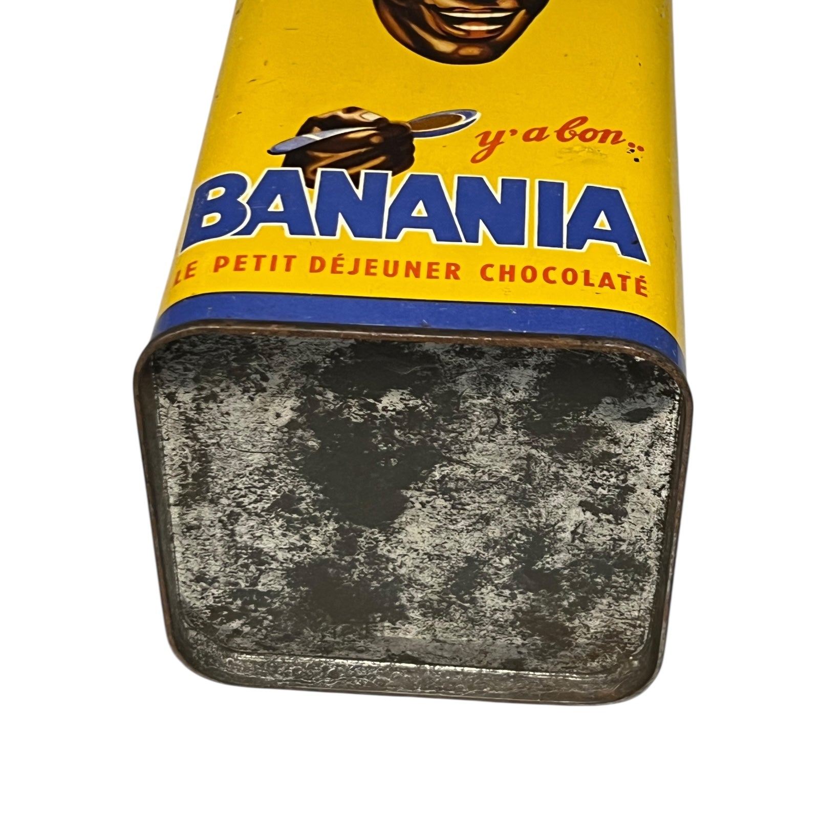 Vintage tin can with a colourful design featuring a face and 'Banania' branding on a white background.