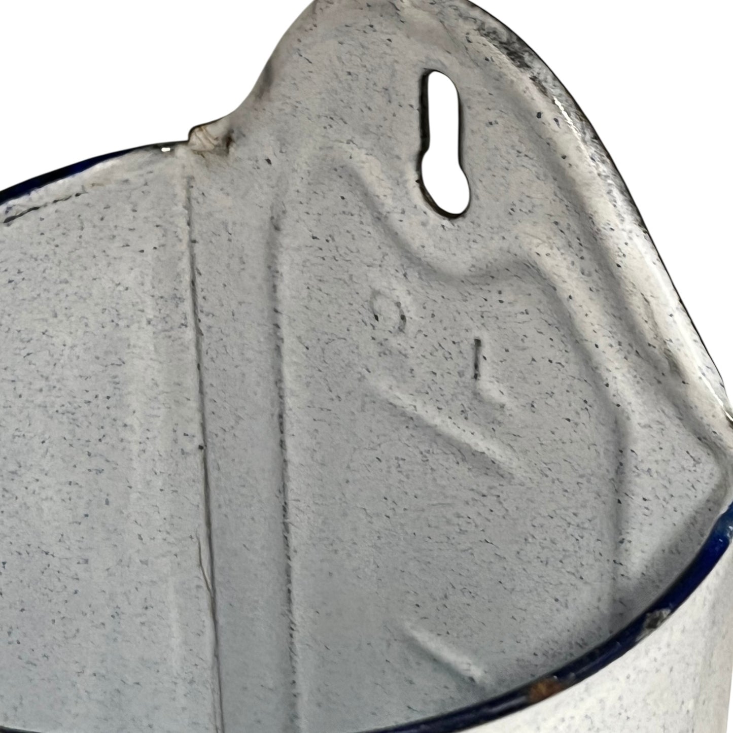 Close-up of an enamel planter with speckled glaze and blue rim on a white background