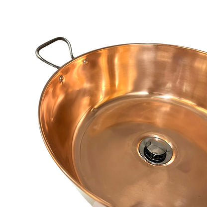 Close up of a copper sink on a white background 