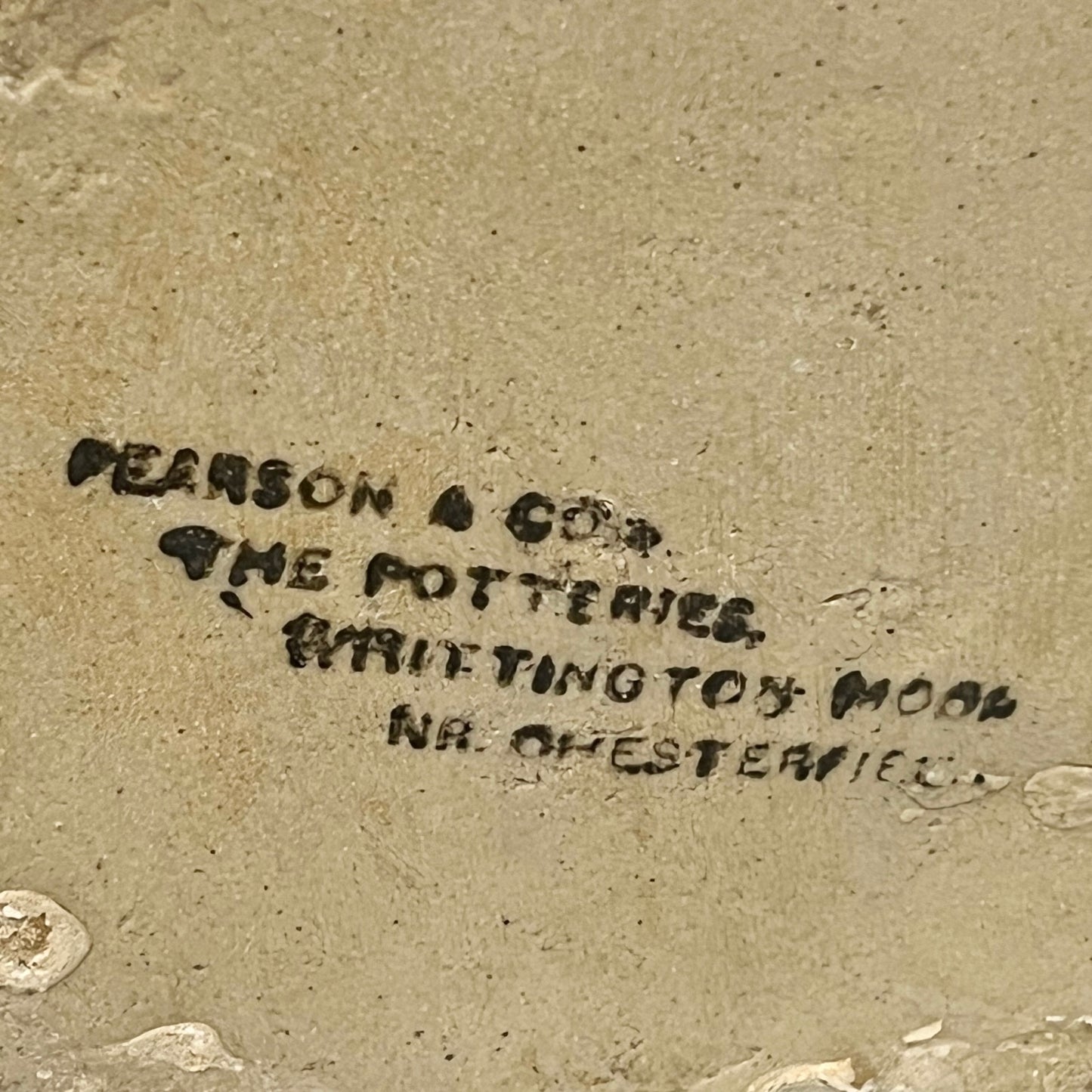 close up of a ww1 SRD jar base with a makers stamp on a white background 