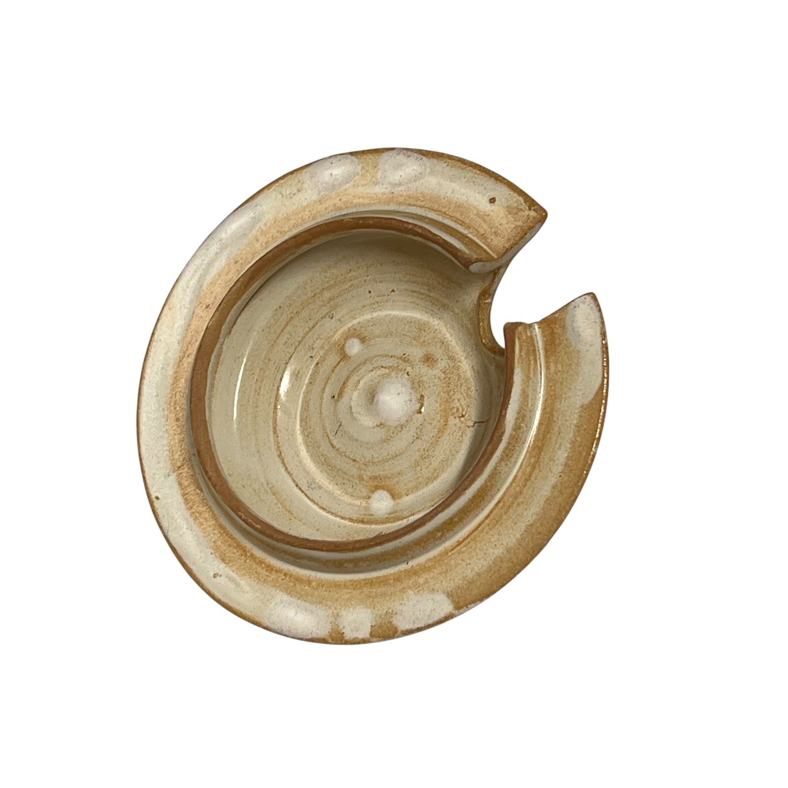 A handmade ceramic lid in earthy beige, brown, and cream tones, shown on a solid white background.