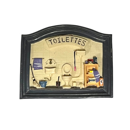 Decorative sign with a bathroom illustration and 'TOILETTES' text on a white background
