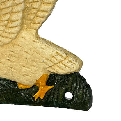 Close-up of a decorative goose head sculpture or wall piece with a textured beige upper body, dark green-black lower head and crest, and a small orange accent near the beak, shown on a white background.