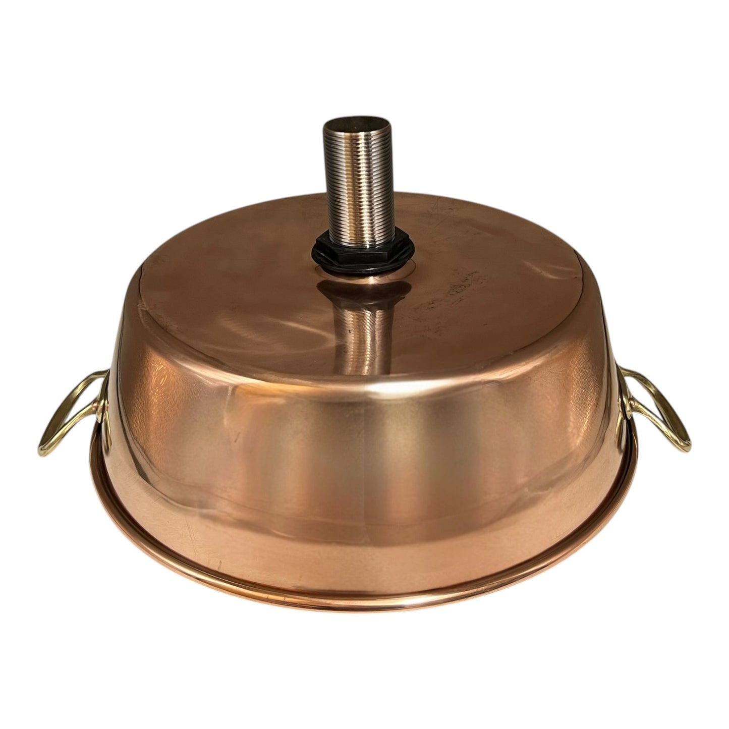 Close-up of a copper sink with a drain plug