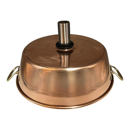 Close-up of a copper sink with a drain plug