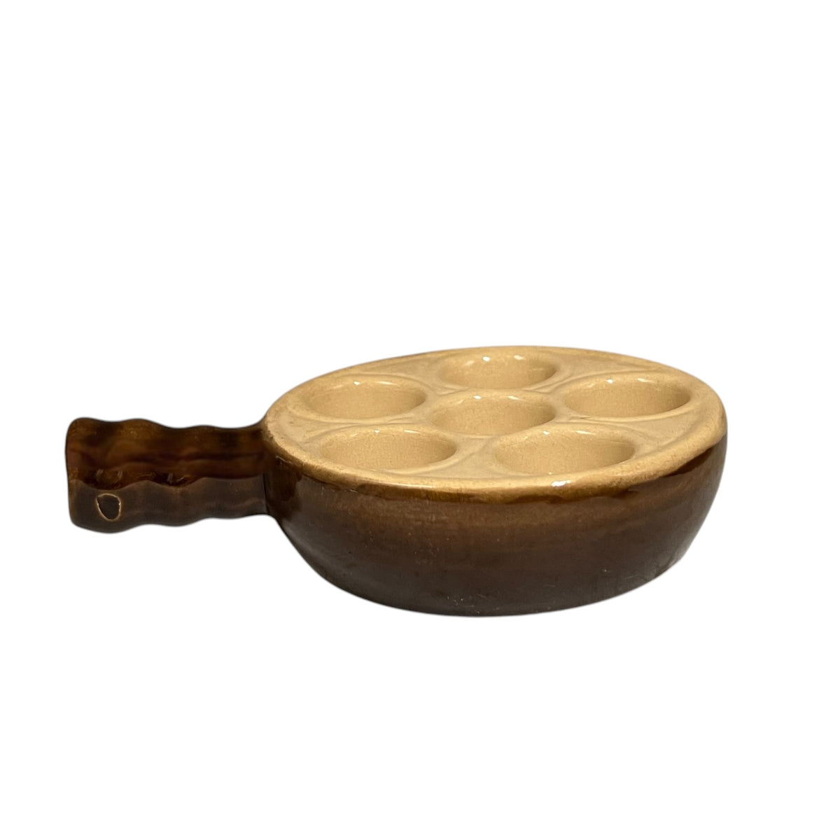 A ceramic six-hole snail plate with a brown exterior and a beige interior, featuring a wavy handle on a white background.