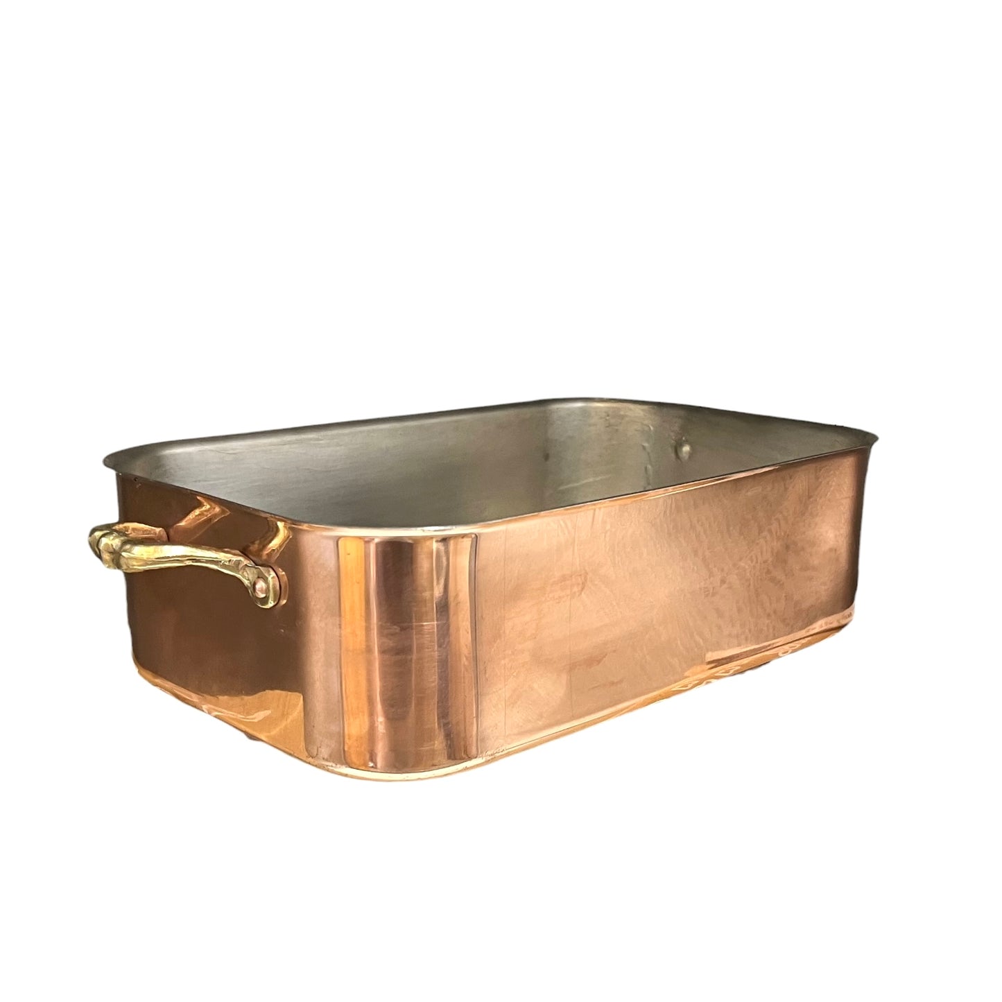 Copper baking dish with a handle on a white background