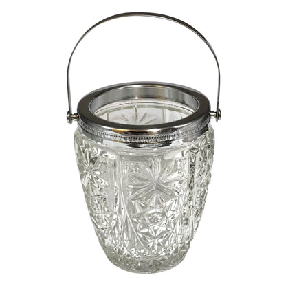 Decorative glass vintage ice bucket with metal collar and handle on a white background
