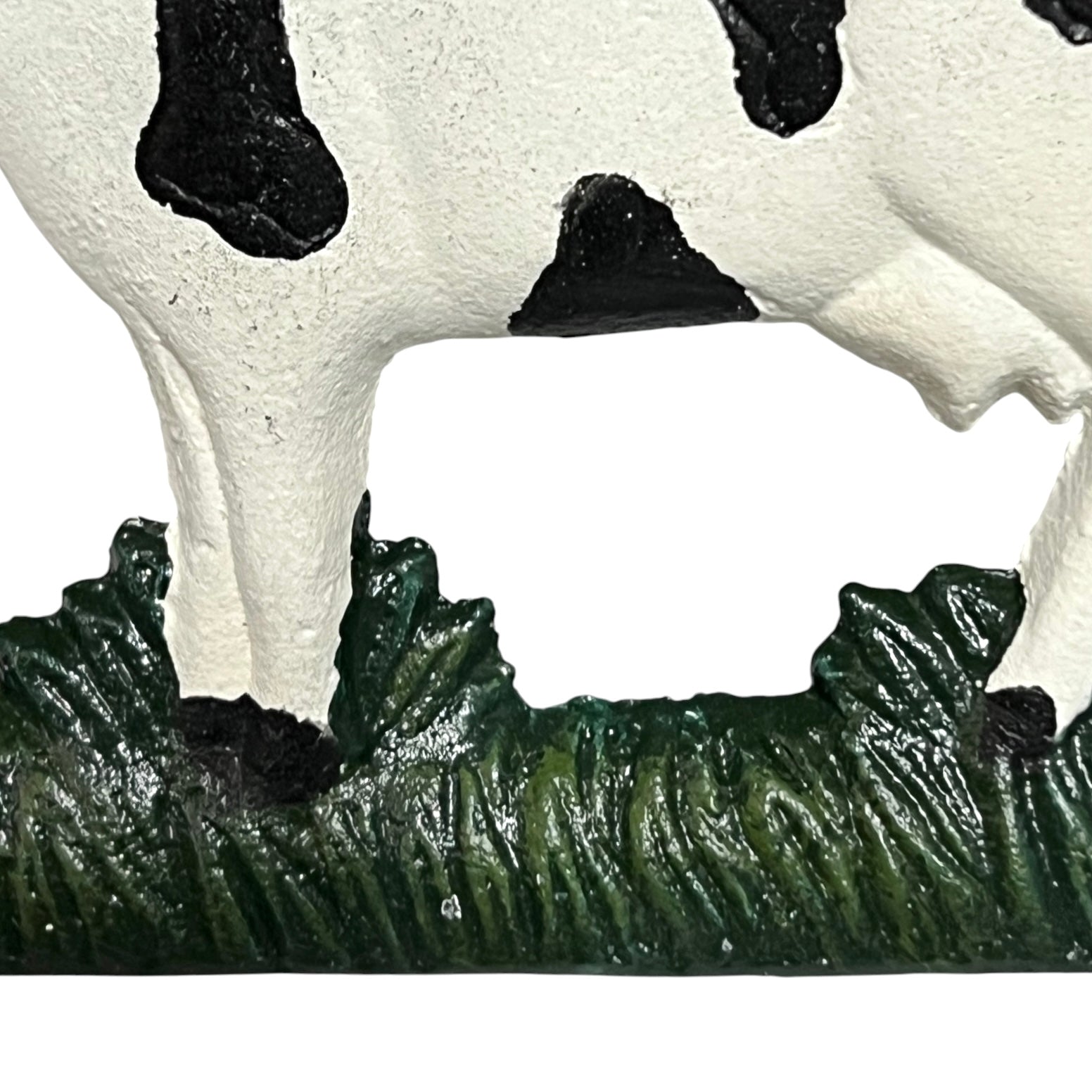 Close-up of a cow toilet roll holder on a white background
