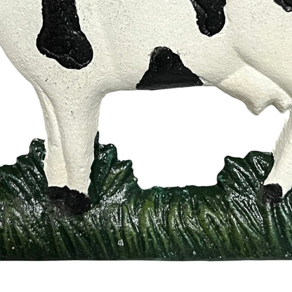 Close-up of a cow toilet roll holder on a white background