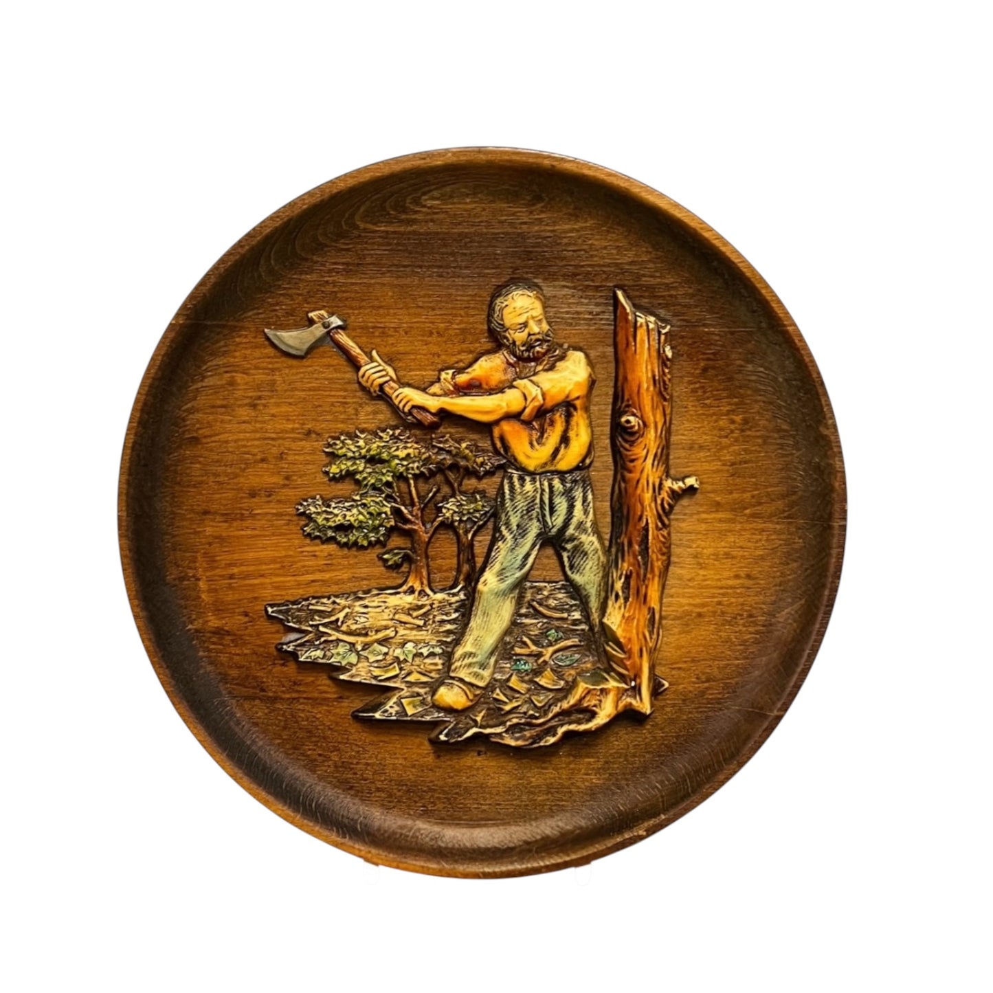 French round vintage wooden wall plaque with a 3d resin/plastic scene in relief of a woodcutter chopping a tree, rustic Arts and Crafts in style, ideal for a country home, set on a white background