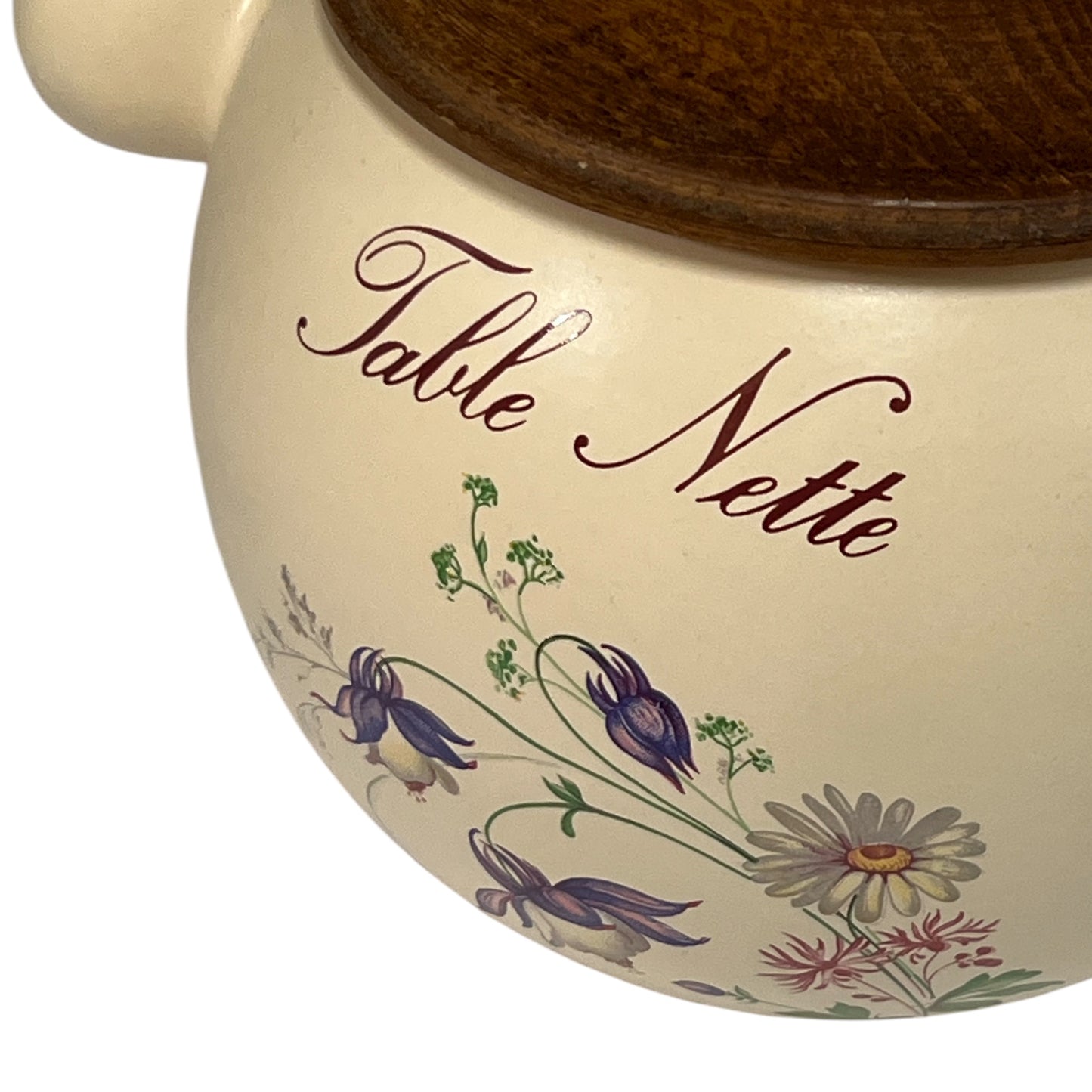 Ceramic pot with floral design and 'Table Nette' text on a white background