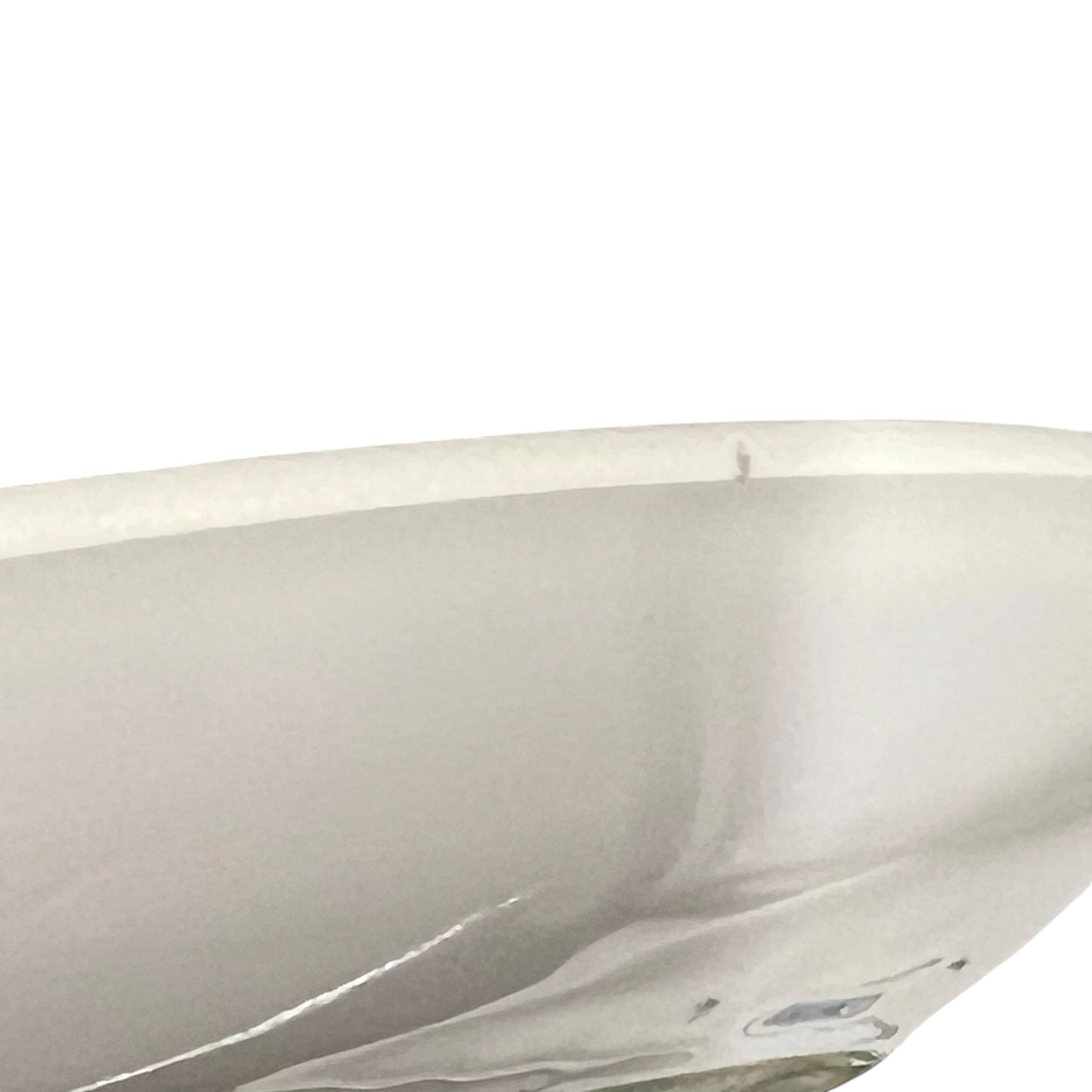 Close-up of a white ceramic bowl with a glossy finish on a white background