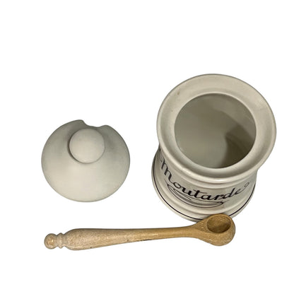 White ceramic mustard container with wooden spoon on a white background