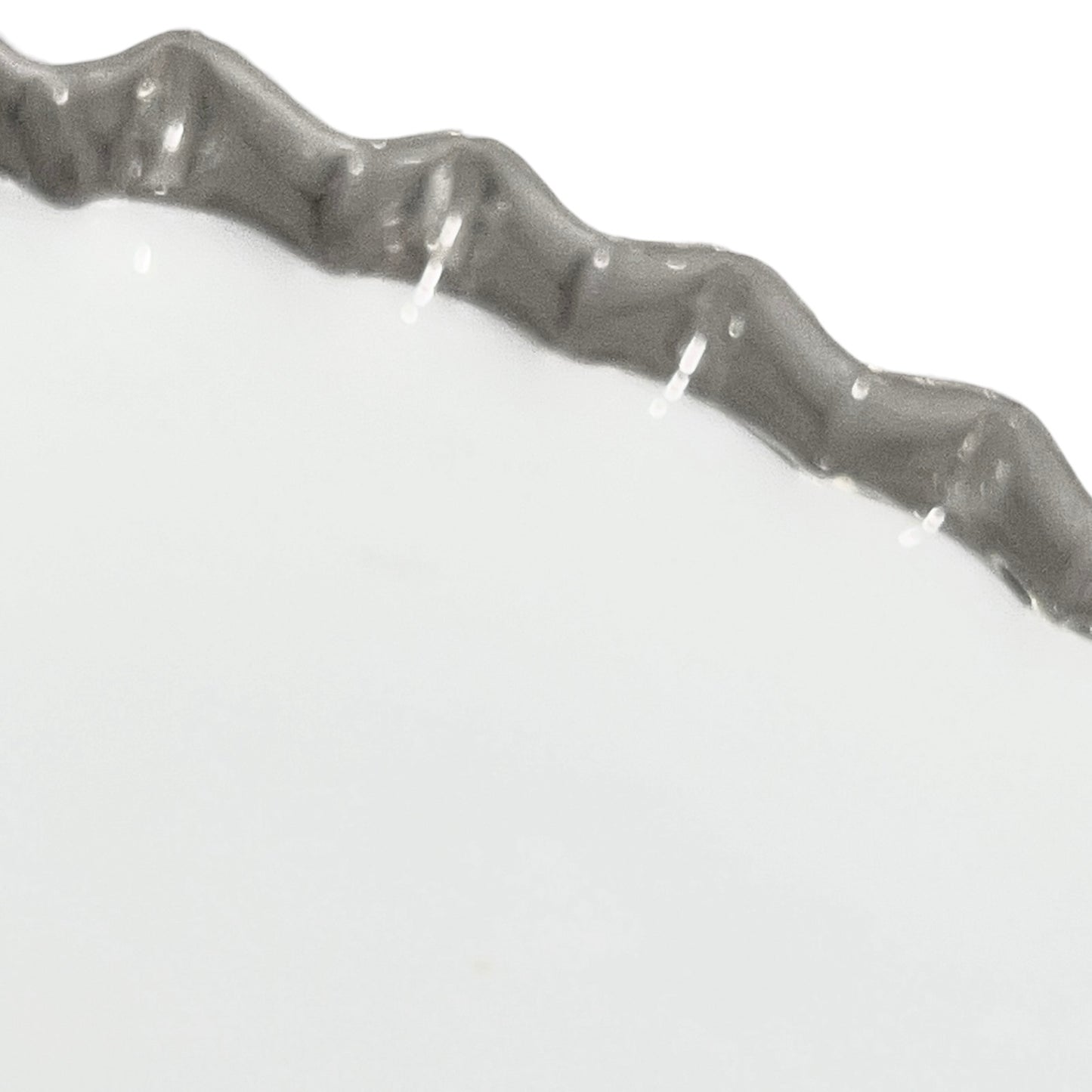 Close-up of a glass lampshade with a decorative edge on a white background