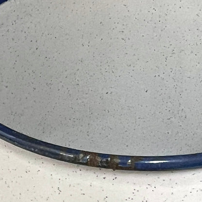 Close-up of a enamel planter with speckled pattern on a white background