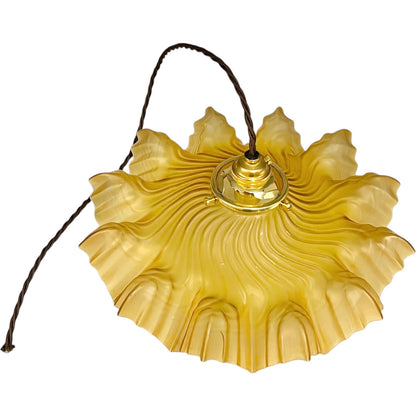 Amber coloured vintage French  pendant light with a scalloped design on a white background